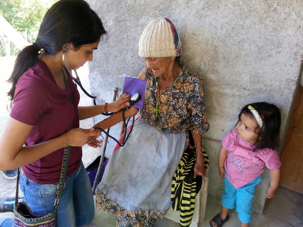 Medical student Sheila Kaypur examines a patient on a home visit in the community of La Majada.