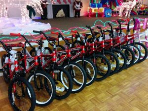 Elbow by volunteers pays off with a roomful of bikes that will be delivered to children through the Toys for Tots program. 